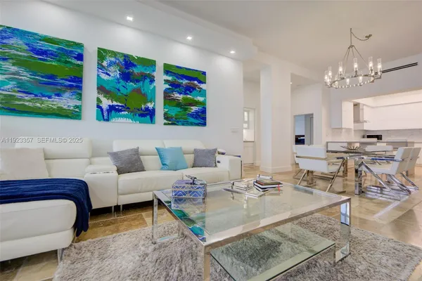 a living room with furniture and painting on the wall