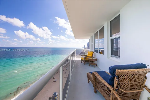 a balcony with chairs and a table