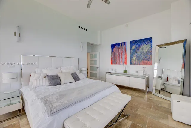 a bedroom with a bed and a couch