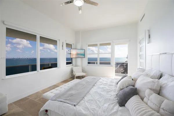 a bedroom with a large bed and a large window