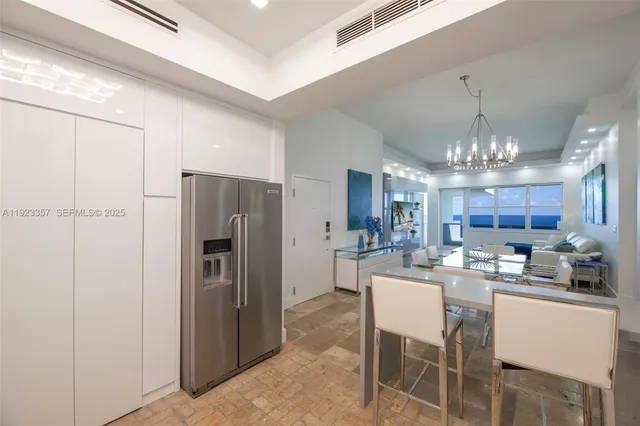 a kitchen with refrigerator and cabinets