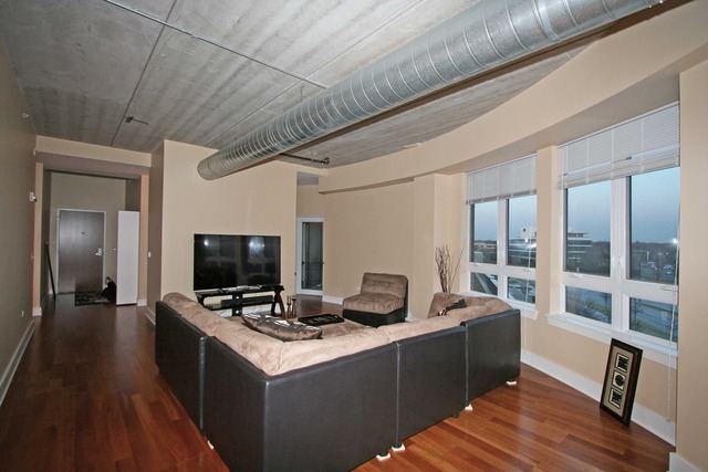 450 Village Center Drive, Unit 305 Burr Ridge, IL 60527 - Photo 2 of 10 a view of a workspace with furniture and wooden floor