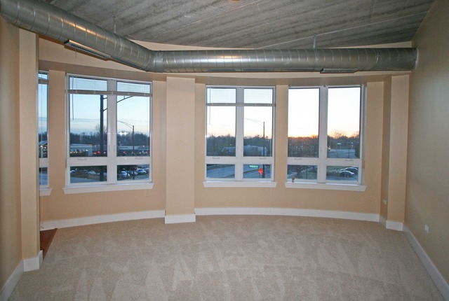 450 Village Center Drive, Unit 305 Burr Ridge, IL 60527 - Photo 3 of 10 a view of an empty room with a window