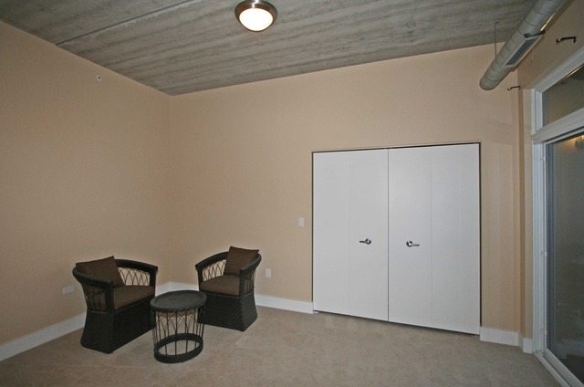 450 Village Center Drive, Unit 305 Burr Ridge, IL 60527 - Photo 9 of 10 a view of a door and chair in a room