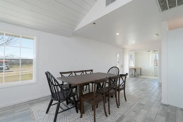 a dining room with furniture and window