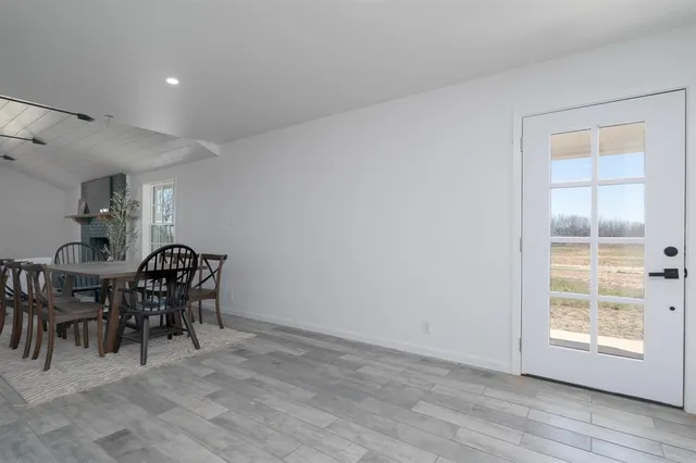 a dining room with furniture and window