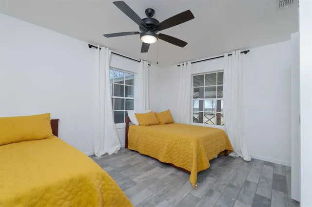 a bedroom with a bed and a ceiling fan