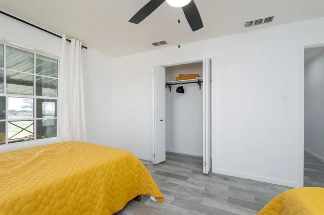 a bedroom with a bed and a window