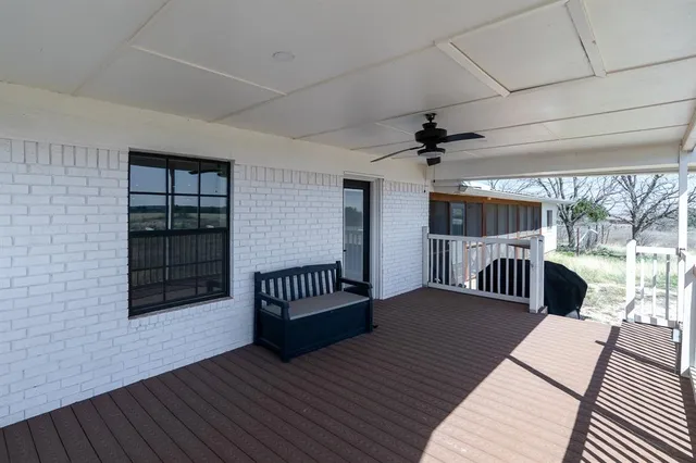a view of a porch with wooden floor and outdoor space