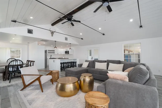 a living room with furniture and a ceiling fan