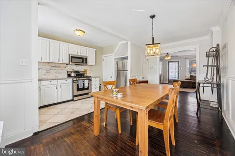 a view of kitchen with cabinets table and chairs