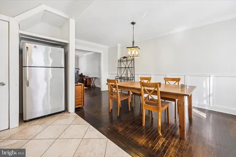 a view of a dining room with furniture wooden floor carpet and a chandelier
