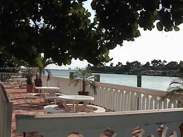 a view of a patio with iron fence
