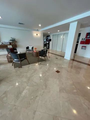 a living room with furniture and a gym machine