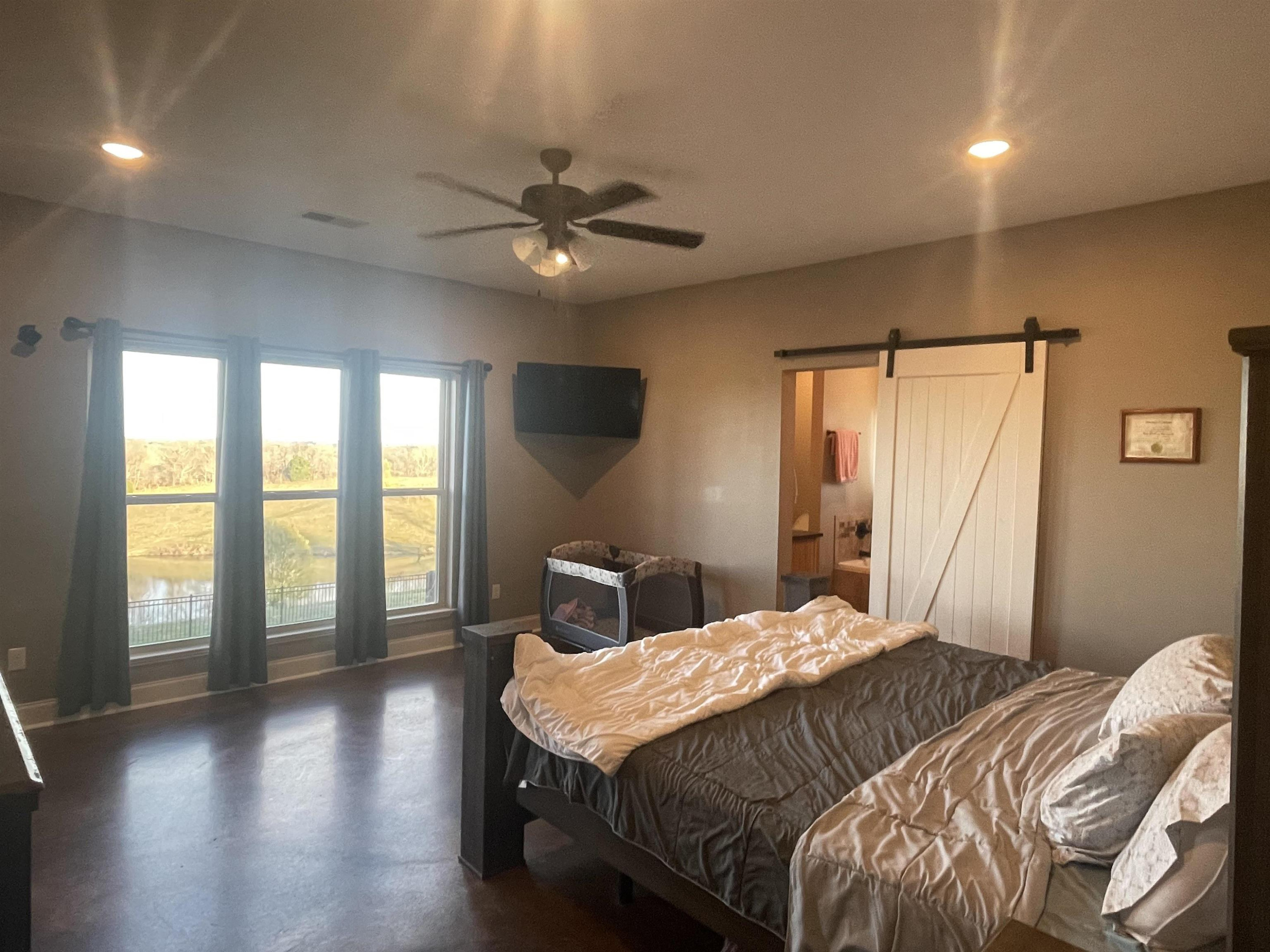 2680 Meacham Road Newbern, TN 38059 - Photo 9 of 13 a bedroom with a large bed and a large window