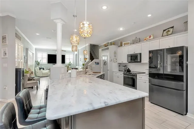 a kitchen with kitchen island granite countertop counter top space appliances and cabinets