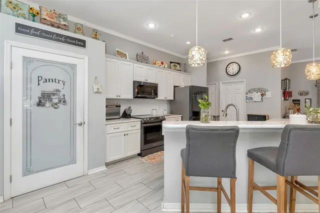 a kitchen with counter top space cabinets and stainless steel appliances