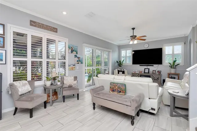 a living room with furniture and a chandelier