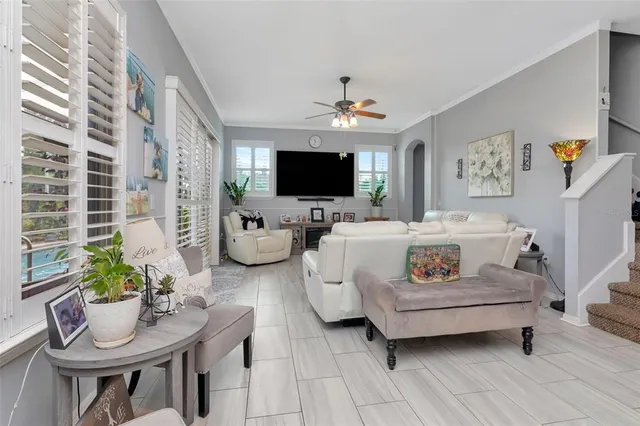 a living room with furniture and large windows