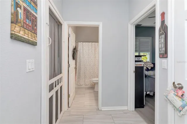 a spacious bedroom with a bed and a flat screen tv