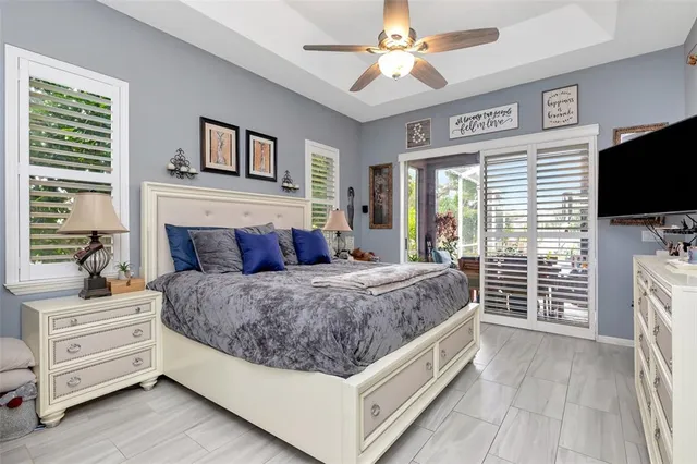 a spacious bedroom with a large bed mirror and a window
