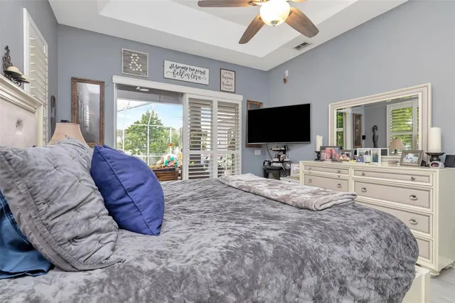 a bath room with a granite countertop toilet a sink and a large mirror