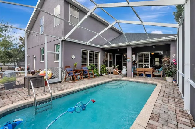 a view of a dining room with furniture wooden floor and chandelier