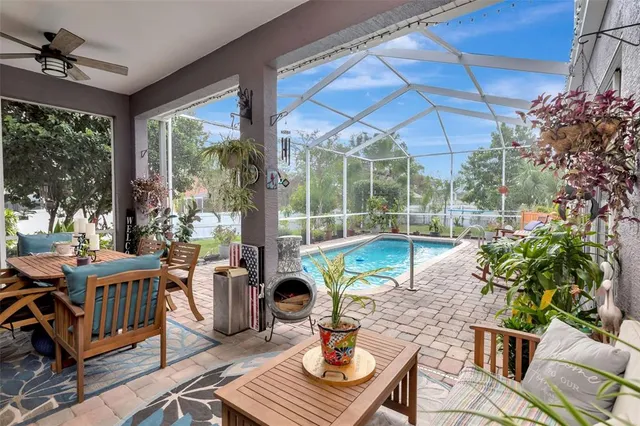 a view of backyard with table and chairs and potted plants