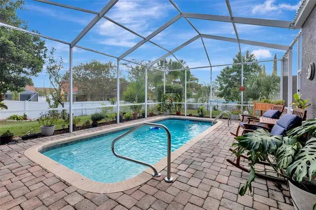 a view of a chair and table in backyard of the house