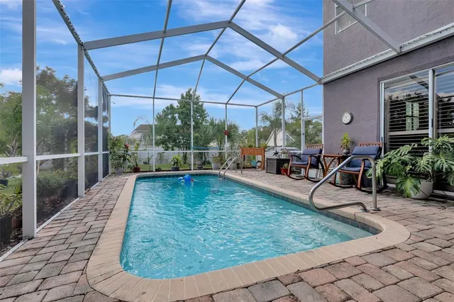a backyard of a house with garden and outdoor seating