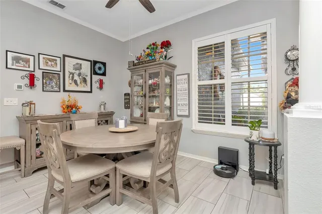 a view of a dining room and livingroom with furniture wooden floor a chandelier