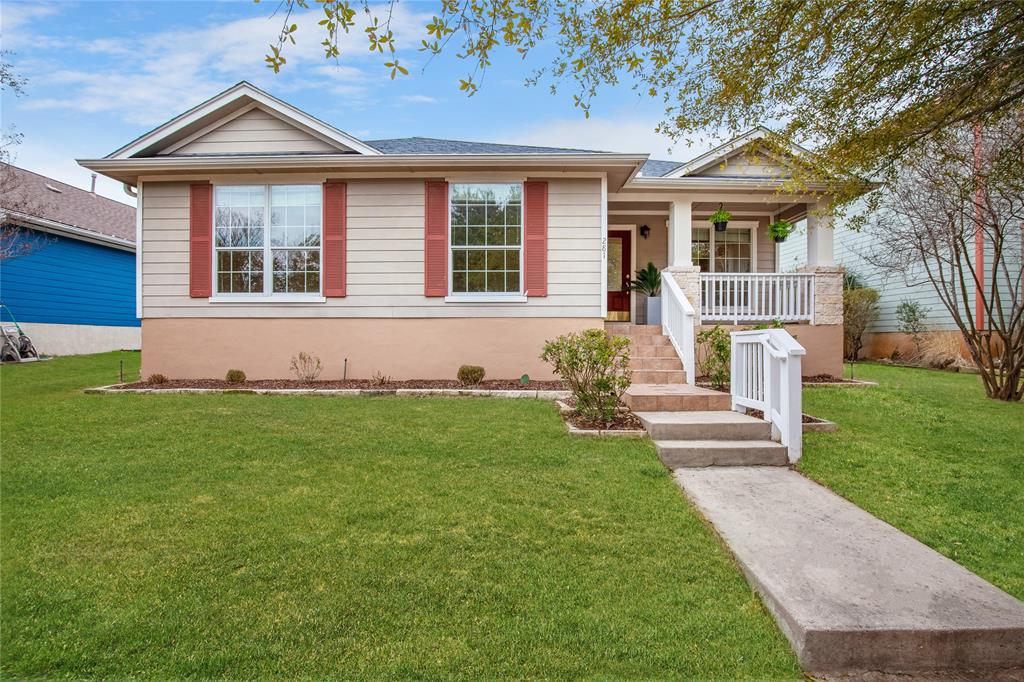 A welcoming facade with a covered porch and neatly maintained lawn beckons.