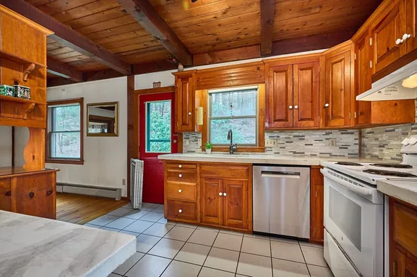 a kitchen with stainless steel appliances granite countertop a sink and cabinets