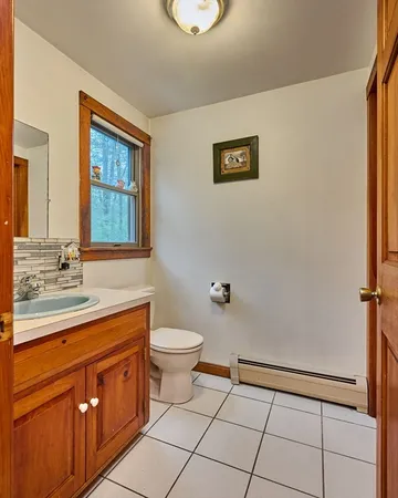 a bathroom with a toilet sink and mirror