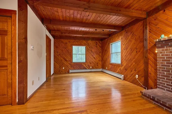 a living room with furniture windows and a wooden floor