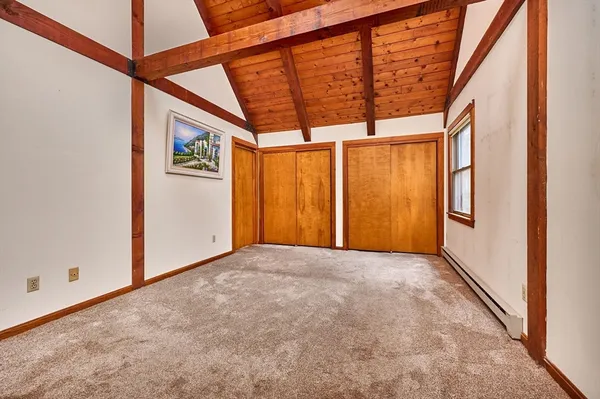 a bedroom with a bed a table and chair