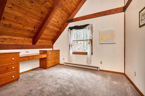 a view of room with a window and furniture