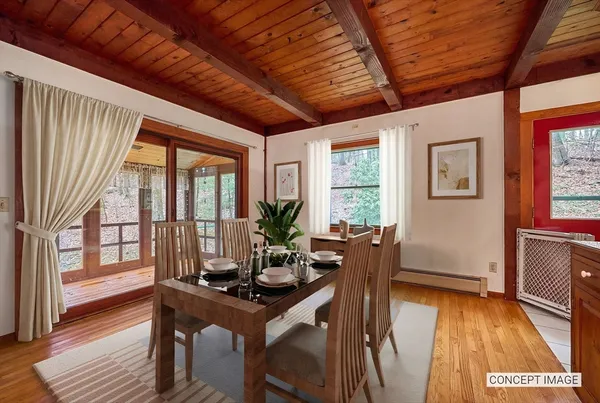 a view of a dining room with furniture window and wooden floor