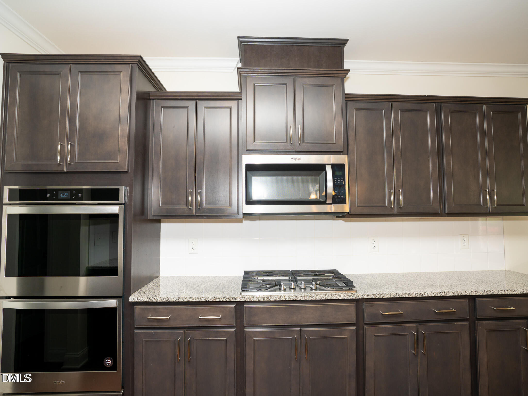 647 Newlyn Drive Raleigh, NC 27606 - Photo 16 of 53 a kitchen with granite countertop stainless steel appliances and wooden cabinets