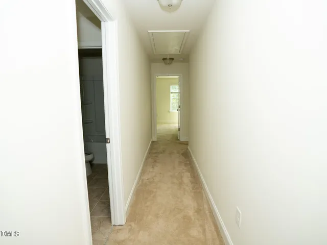 an empty room with windows and ceiling fan view