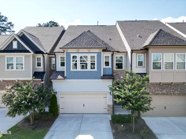 an aerial view of a house with garden space and street view