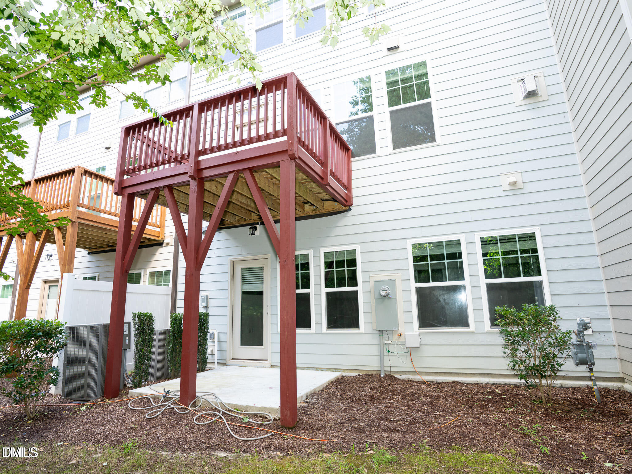 647 Newlyn Drive Raleigh, NC 27606 - Photo 46 of 53 a view of a white house with many windows and plants