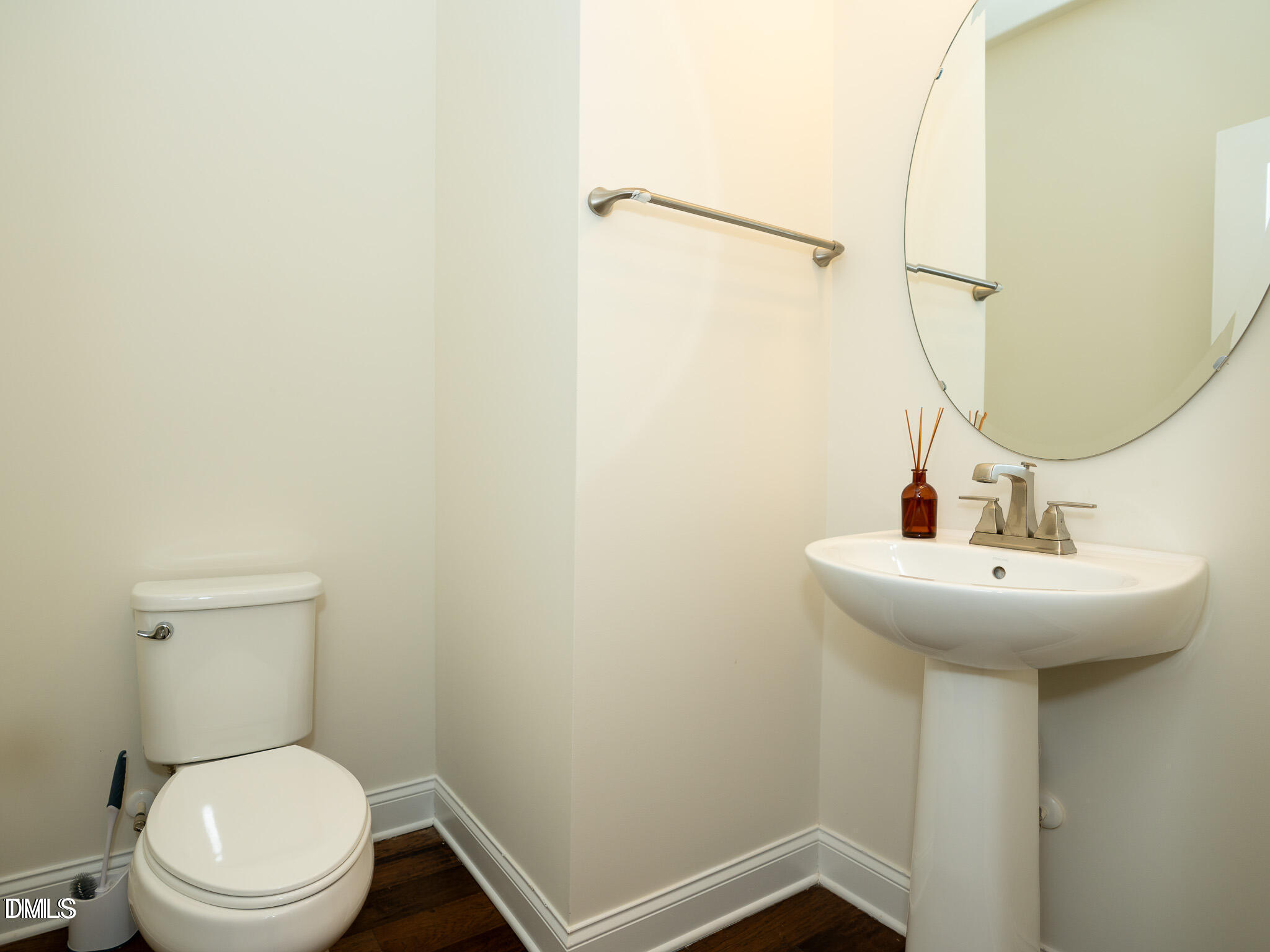 647 Newlyn Drive Raleigh, NC 27606 - Photo 9 of 53 a bathroom with a sink a toilet and a mirror