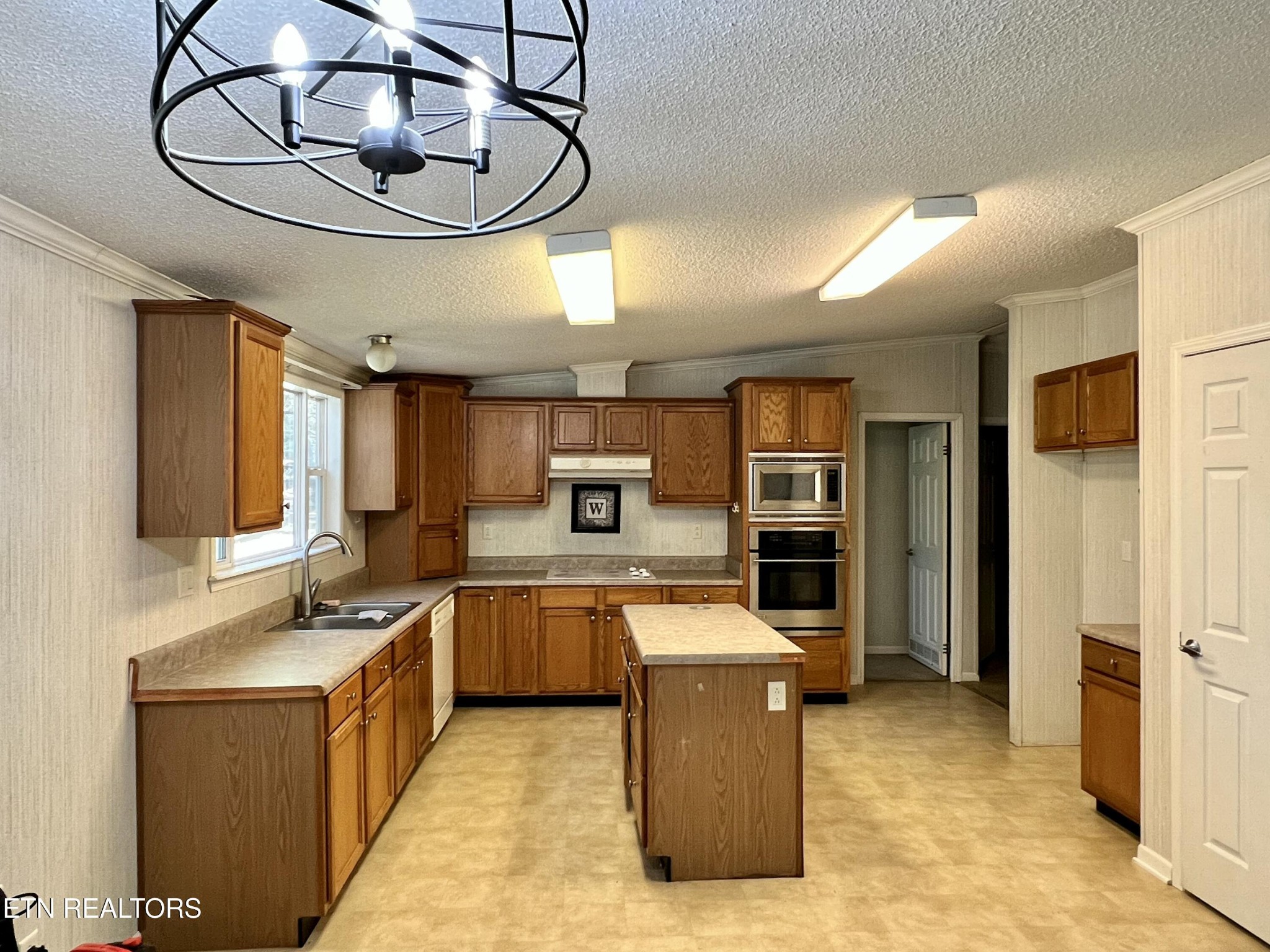 123 Doc Huling Road Robbins, TN 37852 - Photo 20 of 23 a large kitchen with stainless steel appliances granite countertop a sink and cabinets