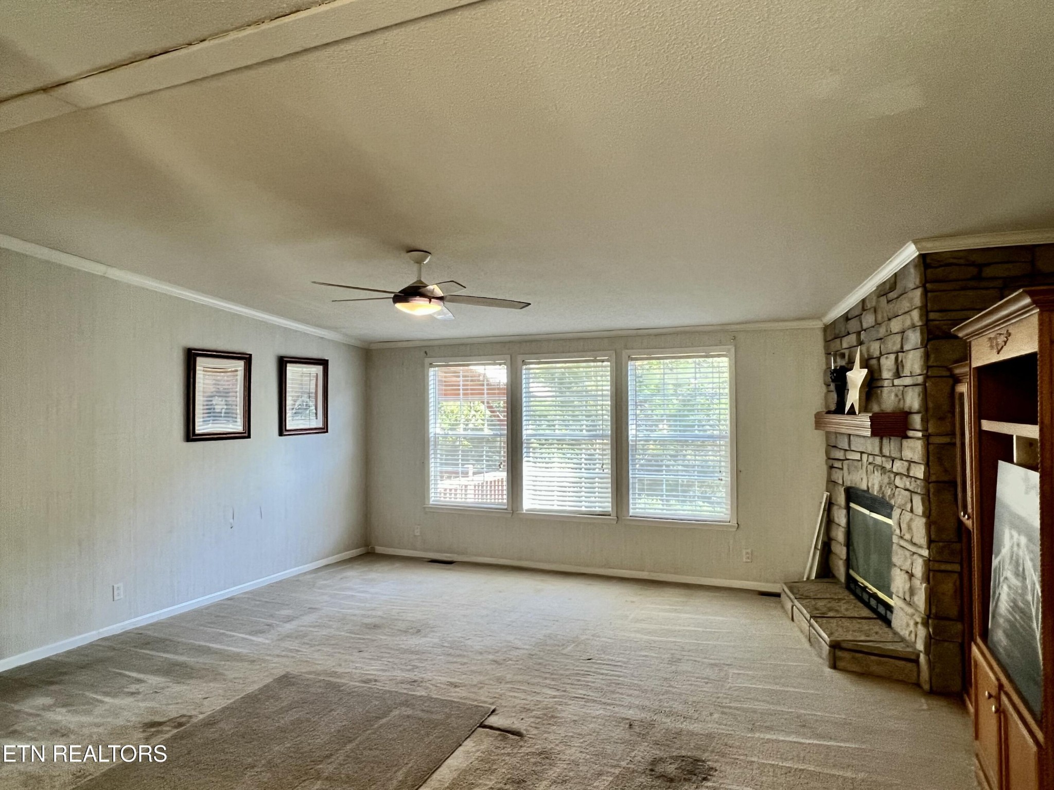 123 Doc Huling Road Robbins, TN 37852 - Photo 21 of 23 a view of an empty room with a fireplace and a window