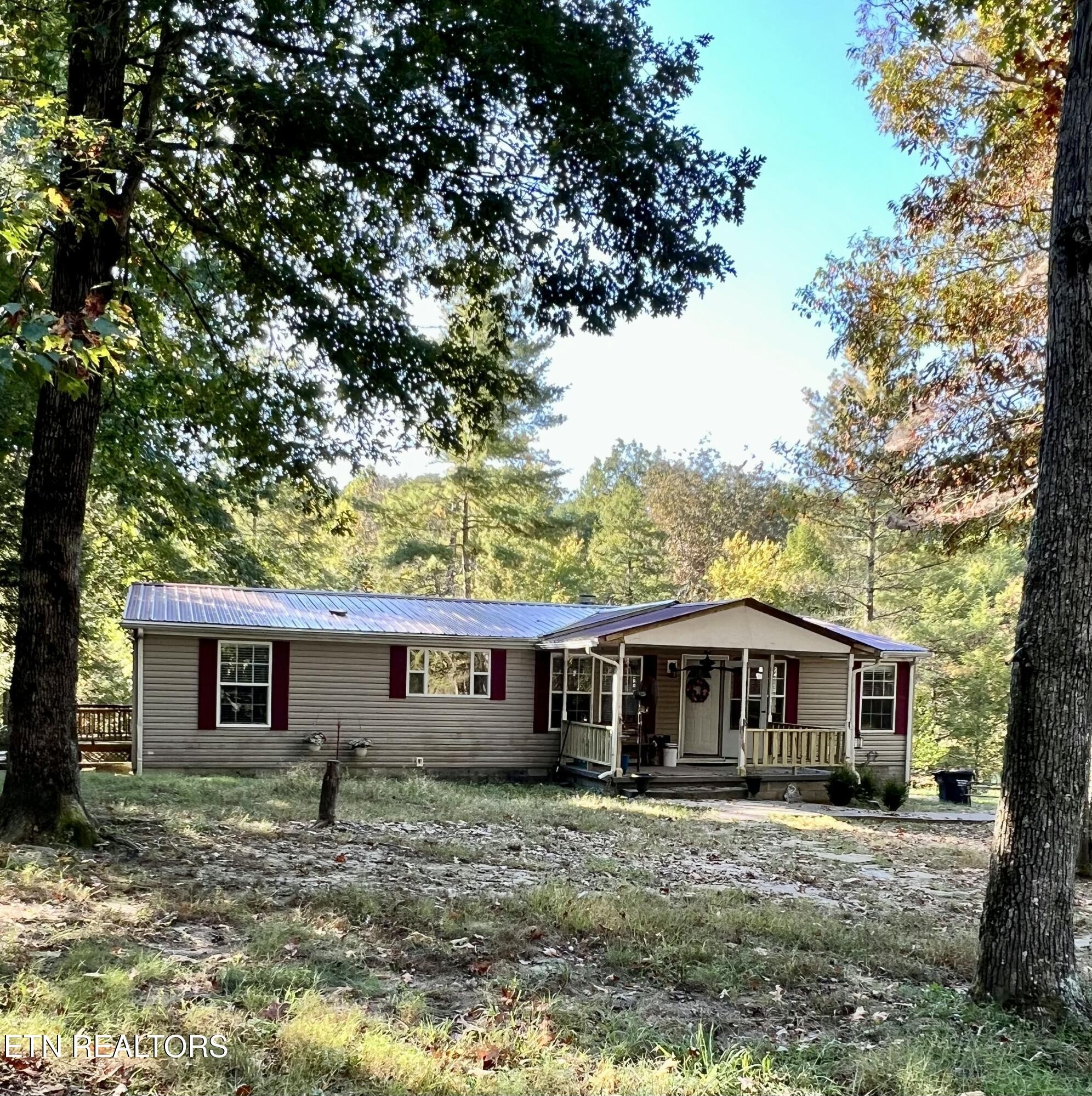 123 Doc Huling Road Robbins, TN 37852 - Photo 5 of 23 a front view of a house with yard