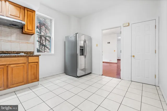 a view of a kitchen with refrigerator and cabinet