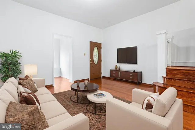 a living room with furniture and a flat screen tv