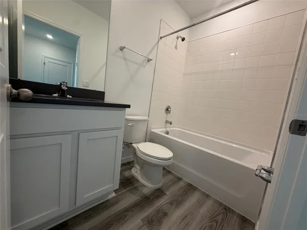 a bathroom with a toilet a sink and a shower