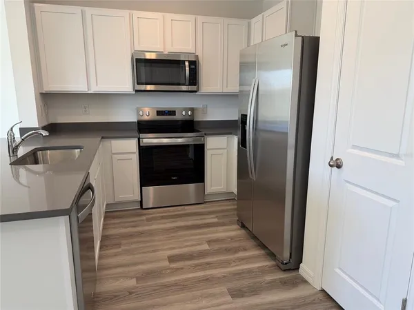 a kitchen with a refrigerator sink and microwave